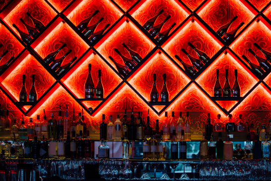 Bottles lit up behind red lighting